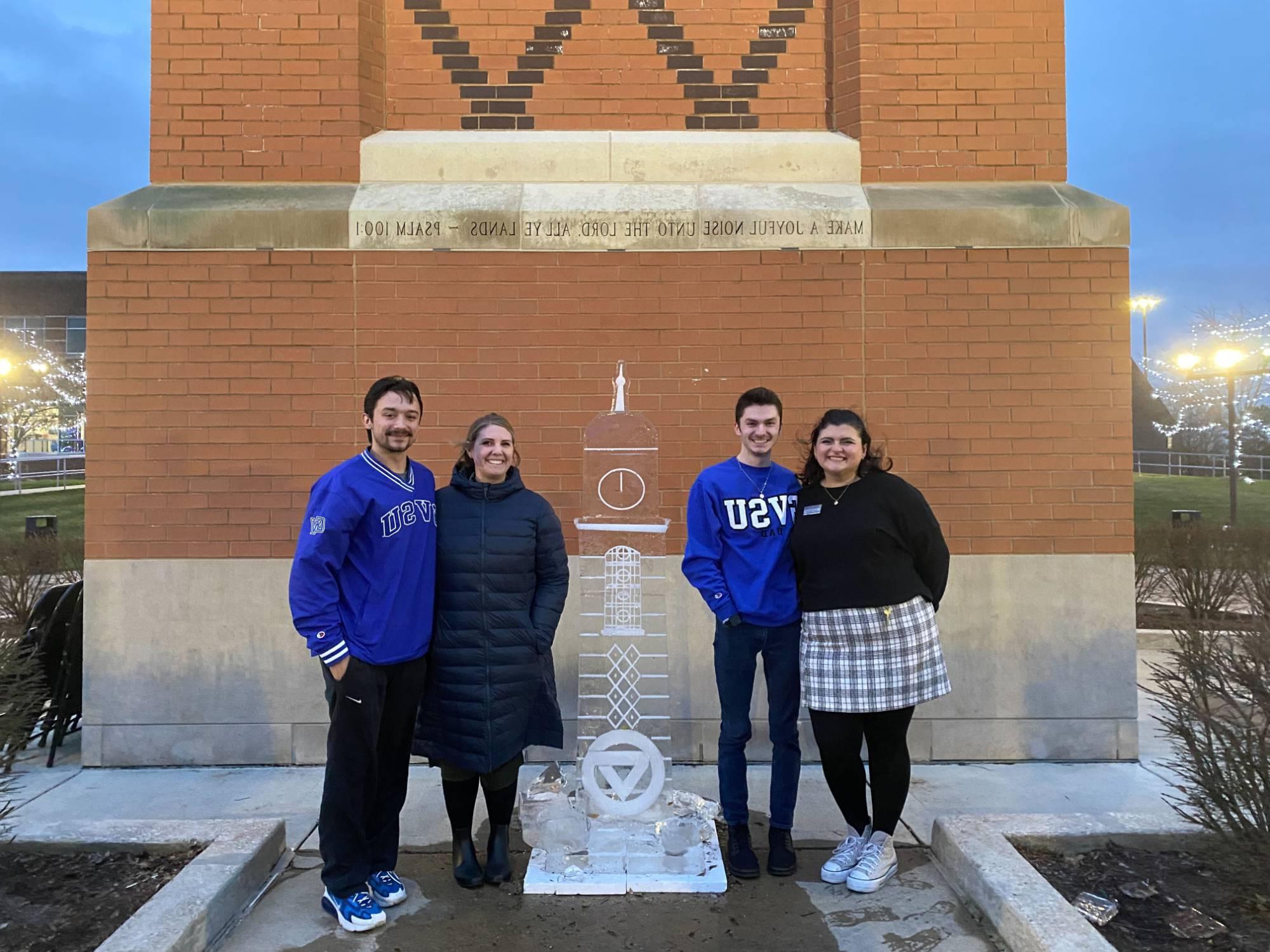 Winterfest Ice Sculpture with CAB members posing behind it